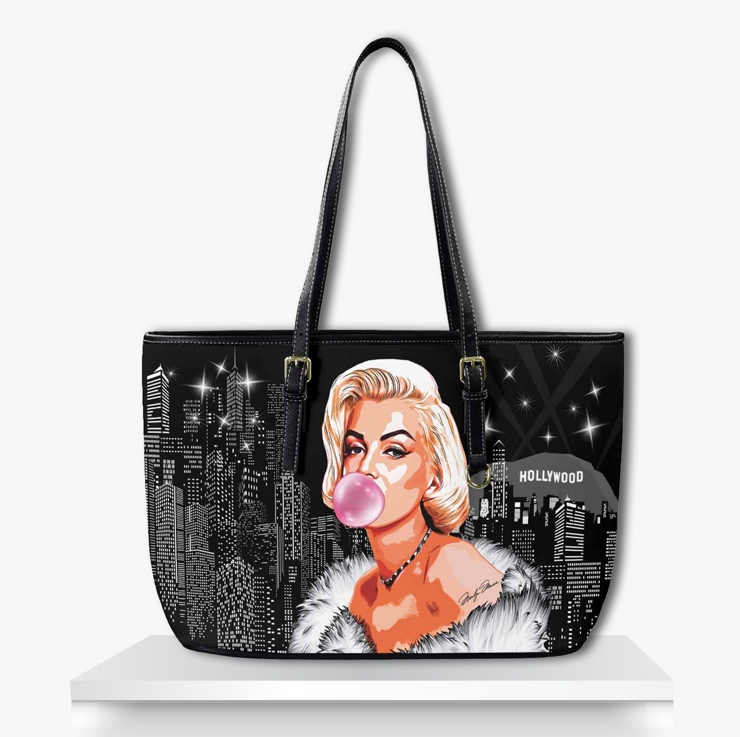 Stylish black tote bag featuring a glamorous illustrated blonde woman in a fur wrap blowing pink bubble gum, set against a sparkling Hollywood cityscape retro-chic fashion accessory blending vintage Hollywood glam with playful pop art vibes.
